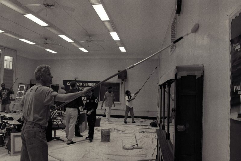 Person painting a wall with a roller