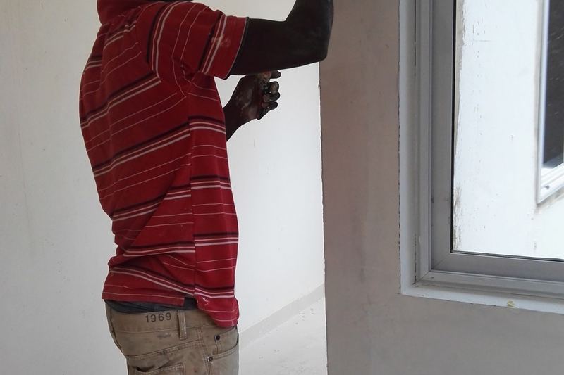 Home painter working on a wall