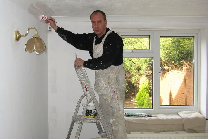 Painter painting a room interior